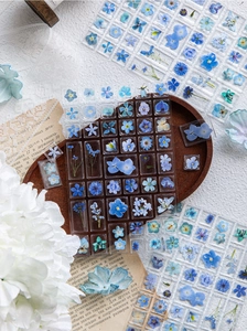 Detailed view of 3D acrylic floral stickers on a vintage tray for DIY phone case craft