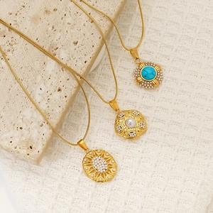 Gold stainless steel necklace set with turquoise pendant, pearl charm, and beaded oval design