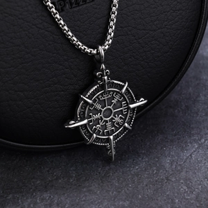 Macro shot of silver Viking Vegvisir compass pendant with vintage finish on black leather