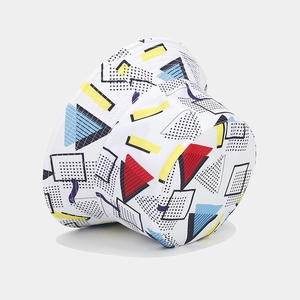 Detail of Memphis style geometric print on the white canvas bucket hat brim and crown
