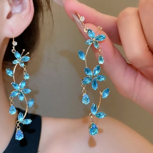 Elegant gold drop earrings featuring sparkling blue zircon butterfly and flower tassels