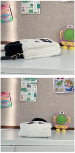 Detail of cute panda plush handbag with soft faux fur texture and black white design