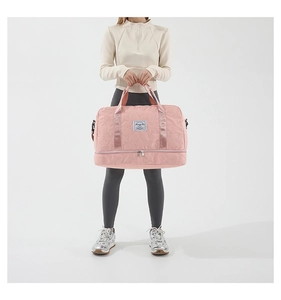 Pink quilted fitness bag with star pattern and separate shoe compartment shown with model