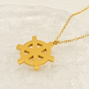 Golden stainless steel ship wheel pendant necklace on a water surface background