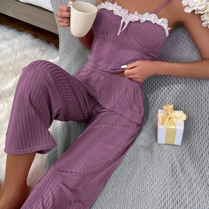 Women's purple ribbed pajama set with delicate white lace trim and pink bow accent