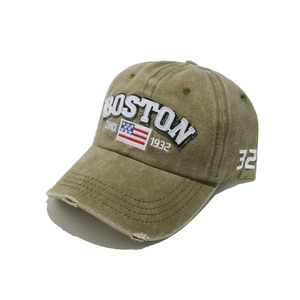 Close-up of vintage washed green baseball cap with BOSTON embroidery and distressed brim