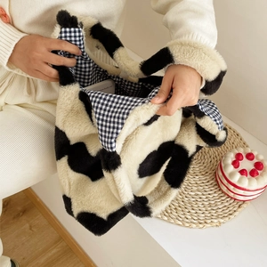Winter heart plush cow print tote bag shown open with black and white checkered lining