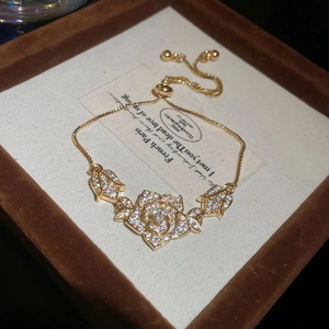 Close-up of elegant gold rose bracelet with sparkling cubic zirconia flower charms