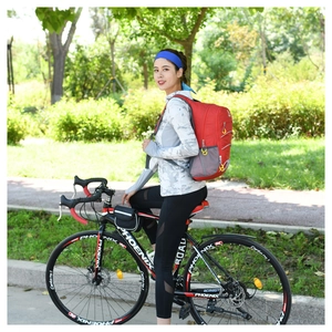 Outdoor cycling scene with a large red sports backpack and a classic road bicycle