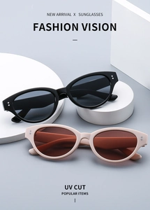 Detail view of small cat eye sunglasses with metal rivet accents and UV cut lenses