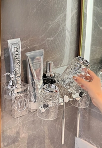 Detail of wall-mounted toothbrush holder with ripple glass texture cups and storage box