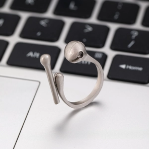 Detailed macro view of retro silver raven claw open ring on a tech background