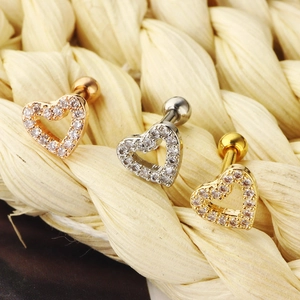 Detail view of heart-shaped cartilage earrings with pavé zircons in three metal finishes