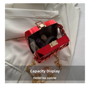 Interior view of red glossy box clutch bag showing capacity for lipstick and makeup
