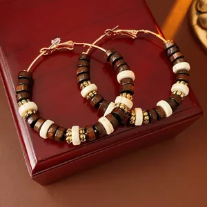 Bohemian large hoop earrings with dark wood beads and white marble accents on gold ring