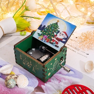 Macro detail of green wooden Christmas music box showing festive interior and metal mechanism