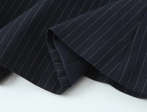 Macro shot of navy blue pinstripe fabric texture with detailed vertical white lines