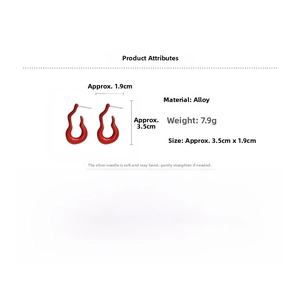 Macro detail of red curved flame stud earrings with size specs and material details