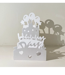 Macro shot of 3D layered white paper cut birthday card with Happy Day hollow design