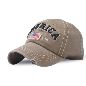 Close-up of distressed khaki baseball cap with AMERICA embroidery and vintage US flag patch