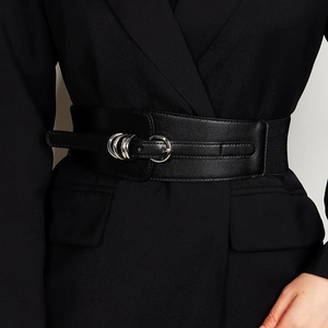 Close-up of black elastic wide waist belt with double silver metal buckle for dresses