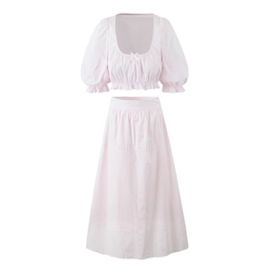Pink two-piece set featuring short puff sleeve crop top and high-waisted midi skirt