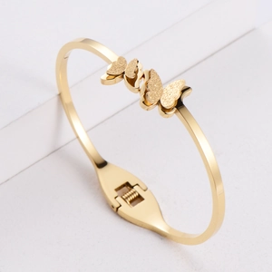 Elegant gold titanium steel butterfly bangle with polished and matte textured finishes