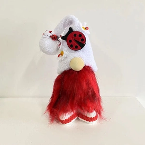 Close-up of red bearded gnome with white plush hat featuring ladybug and daisy details