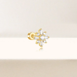 Macro shot of gold-plated S925 silver snowflake ear stud with cubic zirconia stones