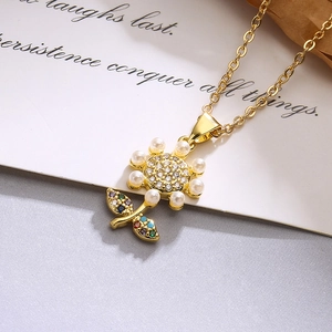 18K gold plated sunflower necklace with pearl petals and zircon crystals on paper