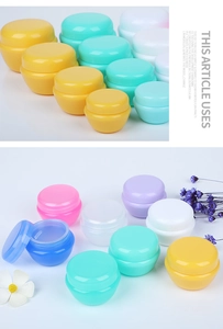 Detailed view of colorful macaron plastic jars with screw caps for cosmetic creams