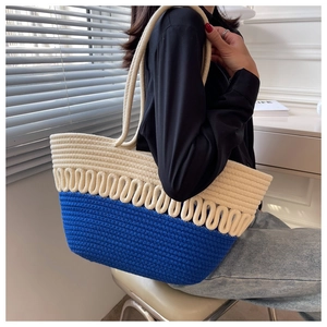 Detail of handwoven tote bag in blue and white bicolor design for summer beach