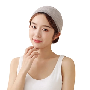 Gray microfiber headband for facial washing shown on a model with soft fabric texture