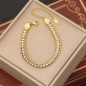 Detailed view of gold chain bracelet with sparkling round cubic zirconia and lobster clasp