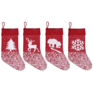 Set of four red knitted Christmas stockings with reindeer and tree patterns