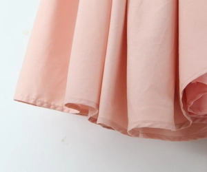 Detail view of pink pleated hem dress showing the high-quality fabric and sewing process