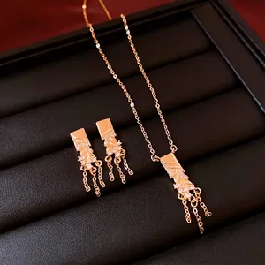 18K gold plated wheat tassel necklace and earrings set on black leather jewelry tray