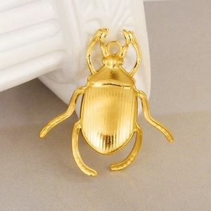 Polished gold-plated 304 stainless steel beetle pendant with a smooth textured reverse side