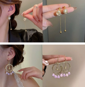 Detail view of pearl floral tassel earrings and purple tulip bell-shaped pendants