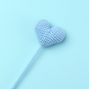 Detail of blue crochet heart handmade with premium yarn on a matching blue background