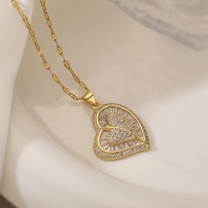 Exquisite gold heart necklace with zircon crystals on a minimalist background