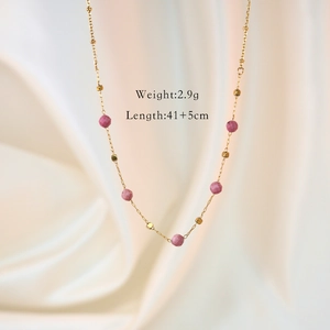 Detail of pink faceted stones and gold square beads on a 41+5cm stainless steel necklace