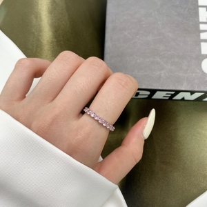 Close-up of pink zircon eternity ring set in S925 sterling silver on model finger