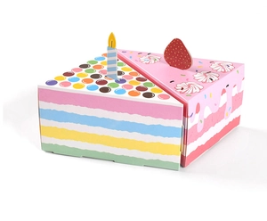 Detailed view of rainbow layered and pink strawberry cake shaped party gift candy boxes