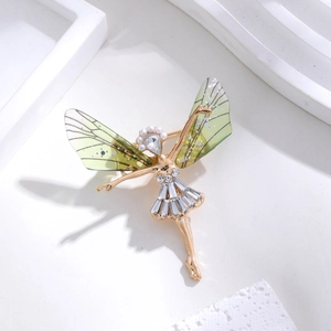 Detailed close-up of golden fairy brooch with green wings and sparkling crystals