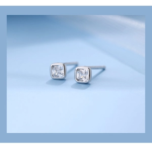 Macro shot of square cubic zirconia silver stud earrings with minimalist geometric design