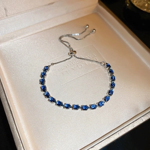 Detail of adjustable silver bracelet with pavé-set blue pear-cut zircon stones