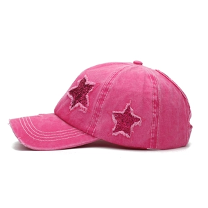 Pink washed distressed baseball cap with sequined star patch and frayed edge detailing