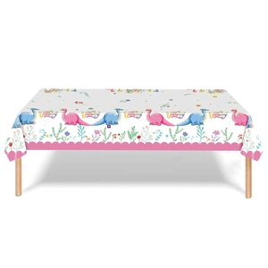 Detail of dinosaur birthday party tablecloth with cute cartoons and floral patterns