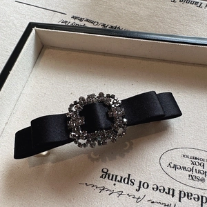 Black satin bow hair clip with sparkling rhinestone square buckle, elegant crystal hair accessory.